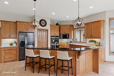 The amazing kitchen features a large island with a two-tiered counter and plenty of space for stools! *Virtually staged to show design options!