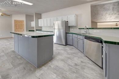 Kitchen has stainless steel appliances and cabinets galore.