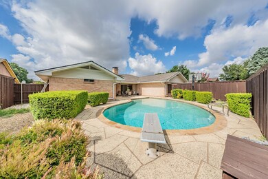 View of pool featuring a diving board and a patio 
