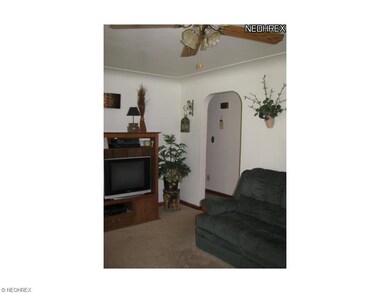 One view of living room towards tiled hallway