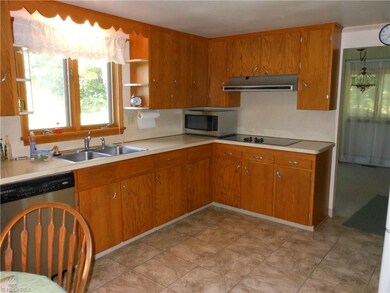 Spacious cheery kitchen comes fully applianced.