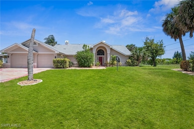 Ranch-style house with stucco siding, a garage, a