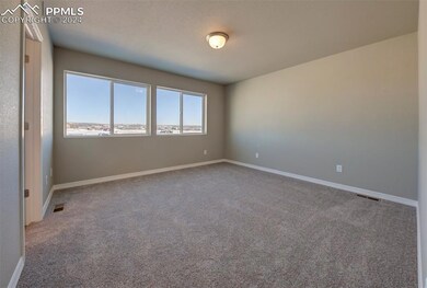 Empty room featuring light carpet