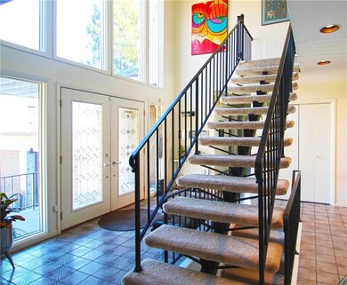 2 story foyer with open staircase and custom wroug