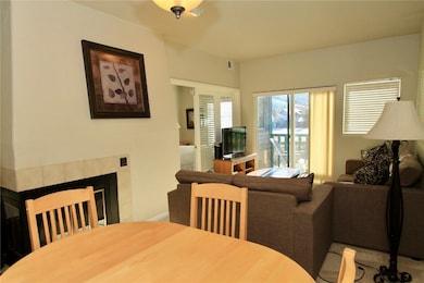 Dining space featuring a tile fireplace and baseboards