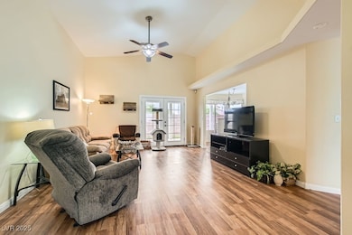 Living area featuring baseboards, wood finished fl