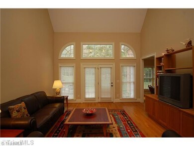 Living Room. Large Living Room with amazing vaulted and coffered ceiling! Hardwood floors and great widows.