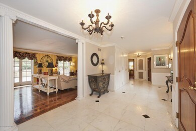 GRAND FOYER OPENS TO FORMAL LIVING ROOM