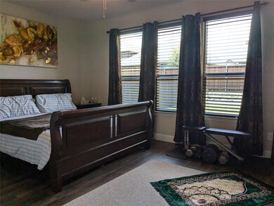 Master Bedroom with dark hardwood / wood-style floors and tall windows
