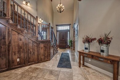 Entrance foyer featuring a notable chandelier, a t