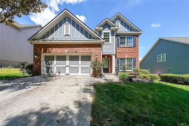 View of front of property with brick siding, board and batten siding, and concrete driveway