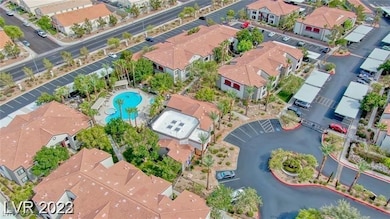 Aerial view of property's location featuring nearby suburban area and a pool area