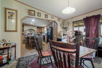 Dining room featuring arched walkways, crown mold