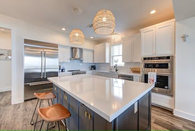 This modern kitchen features a large island with a