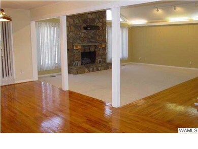 Entryway with shining hardwoods looking into the g