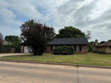 View of front facade featuring a front yard and a garage