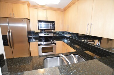 Kitchen with light brown cabinets, appliances with