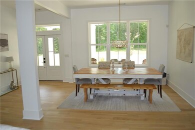 Dining room with healthy amount of natural light, light wood finished floors, and french doors