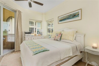 Bedroom with ceiling fan, crown molding, and light