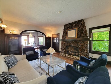 The formal living room with original trim and buil