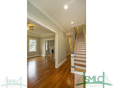 Foyer. Original stairs and handmade stair rail are