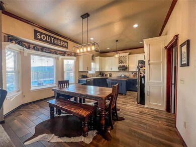 Dining space featuring sink, ornamental molding, a