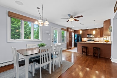 Natural light pours into the combined dining and kitchen space, creating a bright and welcoming environment for everyday meals and entertaining alike.