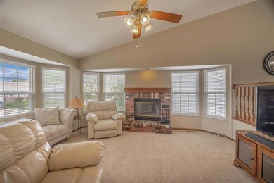 Large great room with bayed windows and vaulted ce