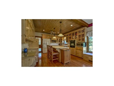 Beautiful wood and glass cabinets and tons of coun