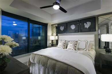 Bedroom with a tray ceiling and ceiling fan