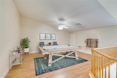 Game room with light wood-style floors, baseboards
