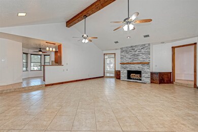 Sunken living room sittings just off the kitchen and formal dining with a gas log fireplace