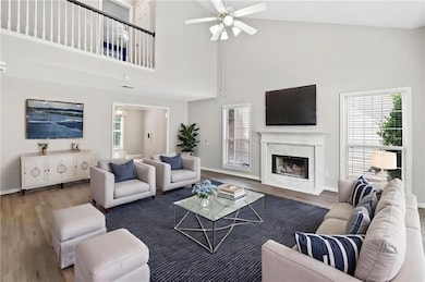 Living area with baseboards, wood finished floors,