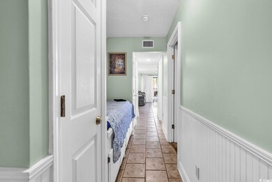 Hall with a textured ceiling