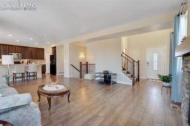 Living room with light hardwood / wood-style floor