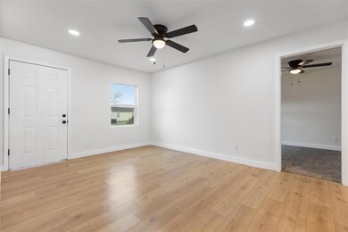 Empty room with light wood-style floors, recessed 