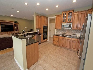 Kitchen. The  hand-glazed maple cabinetry is accen