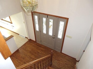 2 Story foyer with beautifully finished hardwood floor, upgraded entrance door & attractive chandelier...
