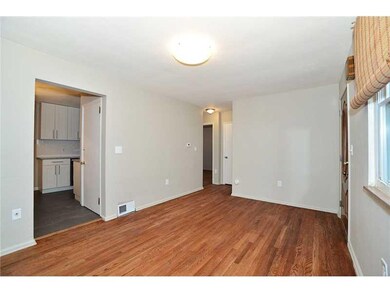 Living Room. Beautiful hardwood floors grace the l