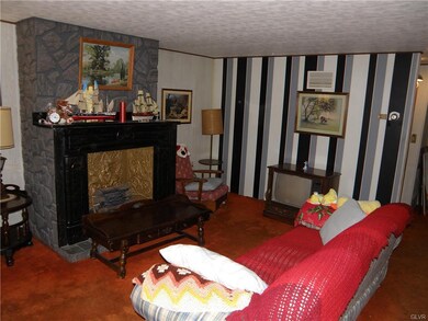 Living room with ornamental fireplace.
