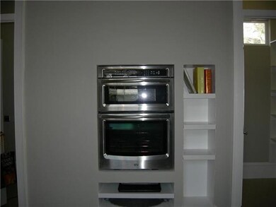 Kitchen. Oven wall flanked by double walki in pant