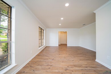 Unfurnished room featuring light wood finished floors, recessed lighting, and ornamental molding