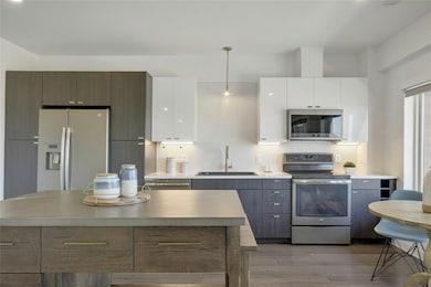 Stainless appliances include an electric range, built-in microwave and dishwasher