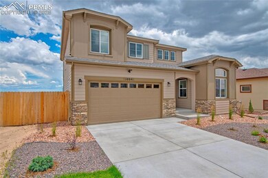 View of front of home featuring stone siding, concrete driveway, a garage, and a shingled roof
