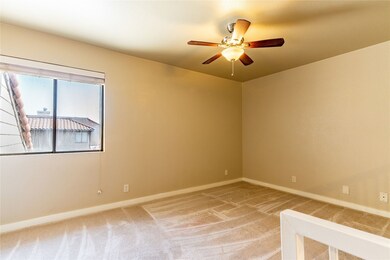 Empty room featuring light colored carpet and a ceiling fan
