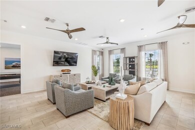 Tiled living room featuring ceiling fan and orname
