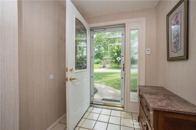 The welcoming foyer has a ceramic tile floor and o