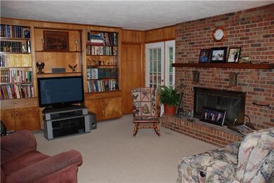 Family room with built in bookcases, access to dec