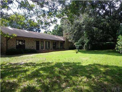 A BIG OAK TREE SHADES THIS LOVELY BACK YARD.