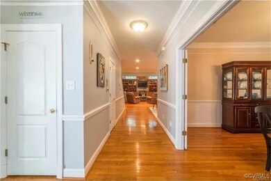 Hall featuring crown molding and light wood-style